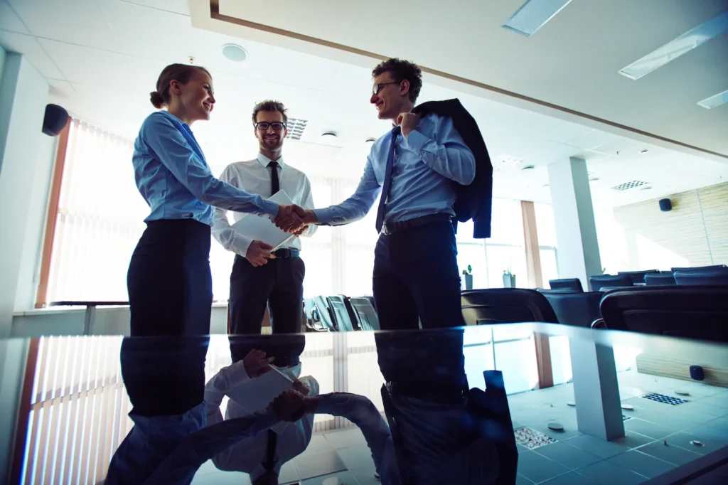 businesspeople shaking hands workplace