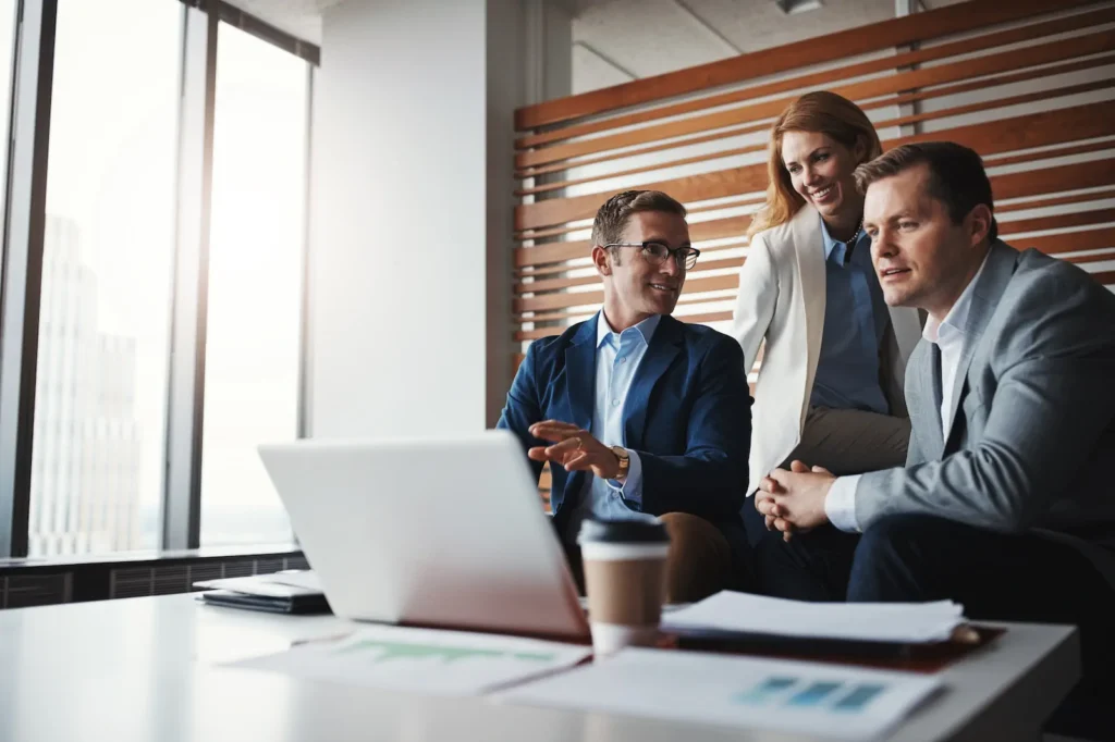 paperwork laptop business people office discussion with revenue profit report meeting team group financial advisors with computer company finance documents workplace